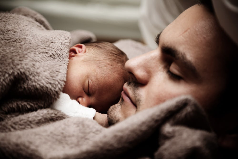 Baby and father sleeping